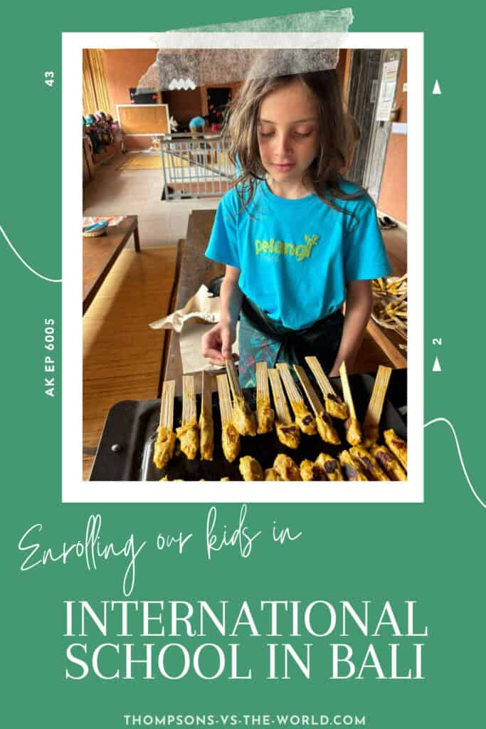 A poloroid style frame in taped to a green background - inside the frame a young boy in a blue school top turns over chicken satay skewers on a BBQ as part of a lesson at international school. The text overlay reads: Enrolling kids in International School in Bali'. Pin to save for later!