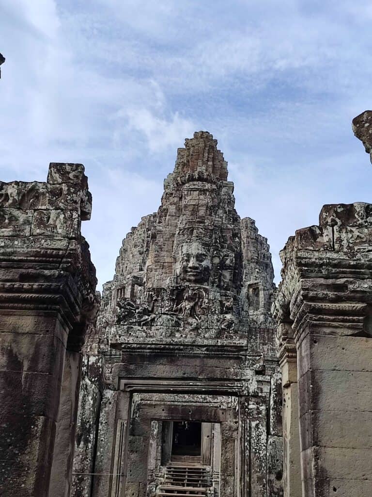 One of the carved faces in the stone of Bayon Temple at Angkor Wat on a visit to Angor Wat with kids