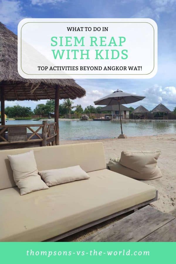 Relaxing beach scene in Siem Reap, featuring a cozy daybed with cushions on a sandy shore next to a serene lake, surrounded by thatched-roof structures and lush greenery under a partly cloudy sky. Text overlay reads "WHAT TO DO IN SIEM REAP WITH KIDS - TOP ACTIVITIES BEYOND ANGKOR WAT!" in green and white. Save this pin to your Pinterest board for later reference.