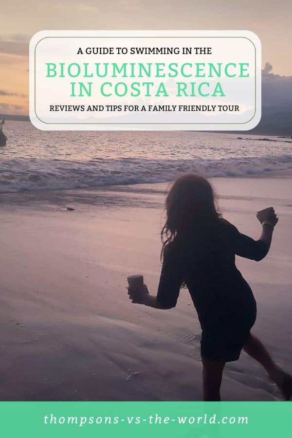 Serene beach scene at sunset in Costa Rica, with a silhouette of a boy holding a cup walking along the shoreline as waves gently roll in. Text overlay reads "A GUIDE TO SWIMMING IN THE BIOLUMINESCENCE IN COSTA RICA - Reviews and tips for a family-friendly tour" in green and white. Perfect for families planning a magical bioluminescence experience! Save this pin to your Pinterest board for later reference.