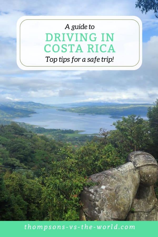 Picturesque landscape in Costa Rica of lush jungle and a blue lake in the distance. Text overlay reads 'A Guide to Driving in Costa Rica: Tops tips for a safe trip!'. Save this pin to your Pinterest Board for planning later!