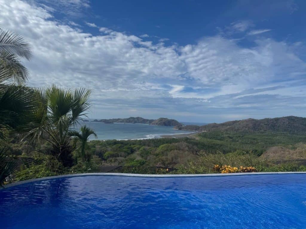 View across an infinity pool looking out to the rainforest and ocean beyond at Olas Verdes Hotel, Nosara, Costa Rica
