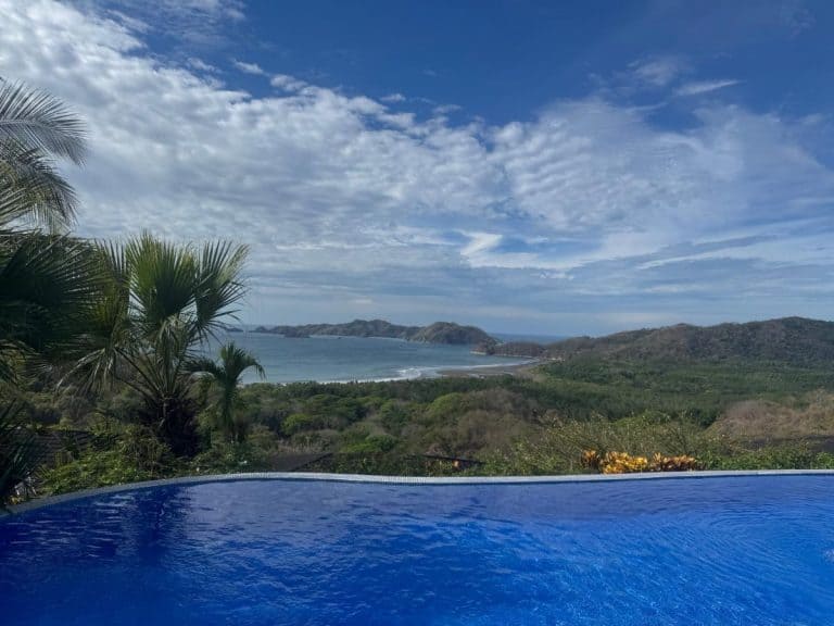 View across an infinity pool looking out to the rainforest and ocean beyond at Olas Verdes Hotel, Nosara, Costa Rica