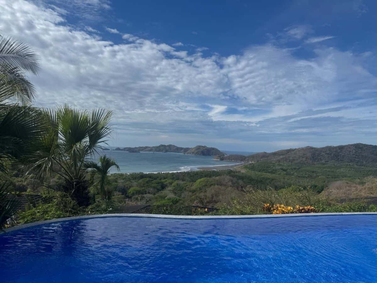 View across an infinity pool looking out to the rainforest and ocean beyond at Olas Verdes Hotel, Nosara, Costa Rica